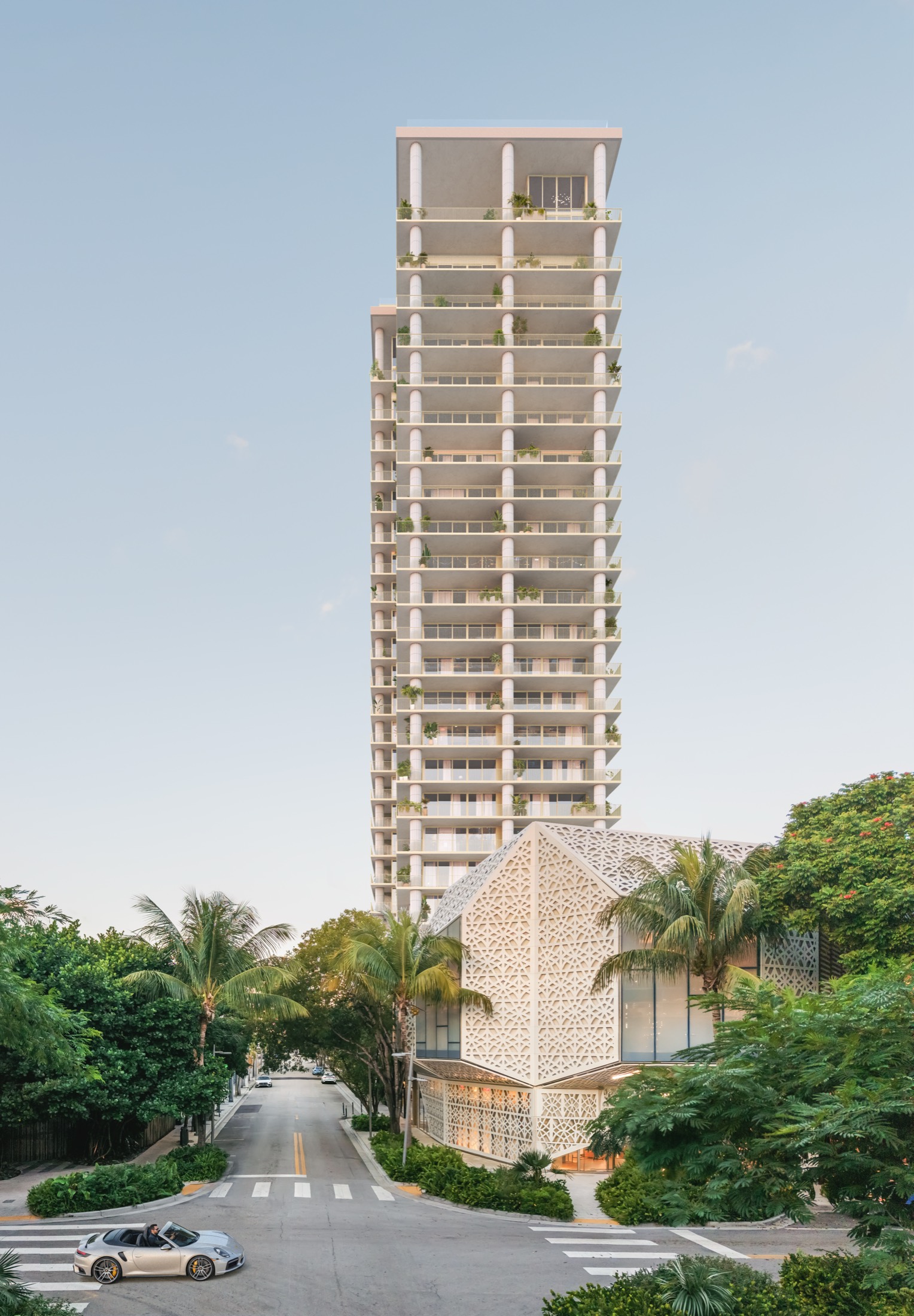 Fouquet's Hotel & Residences seen from 39 NE 39th Street — a 25-story David Chipperfield tower with deep planted terraces and rounded columns above a cream stone-lattice podium, framed by palms in the Miami Design District.