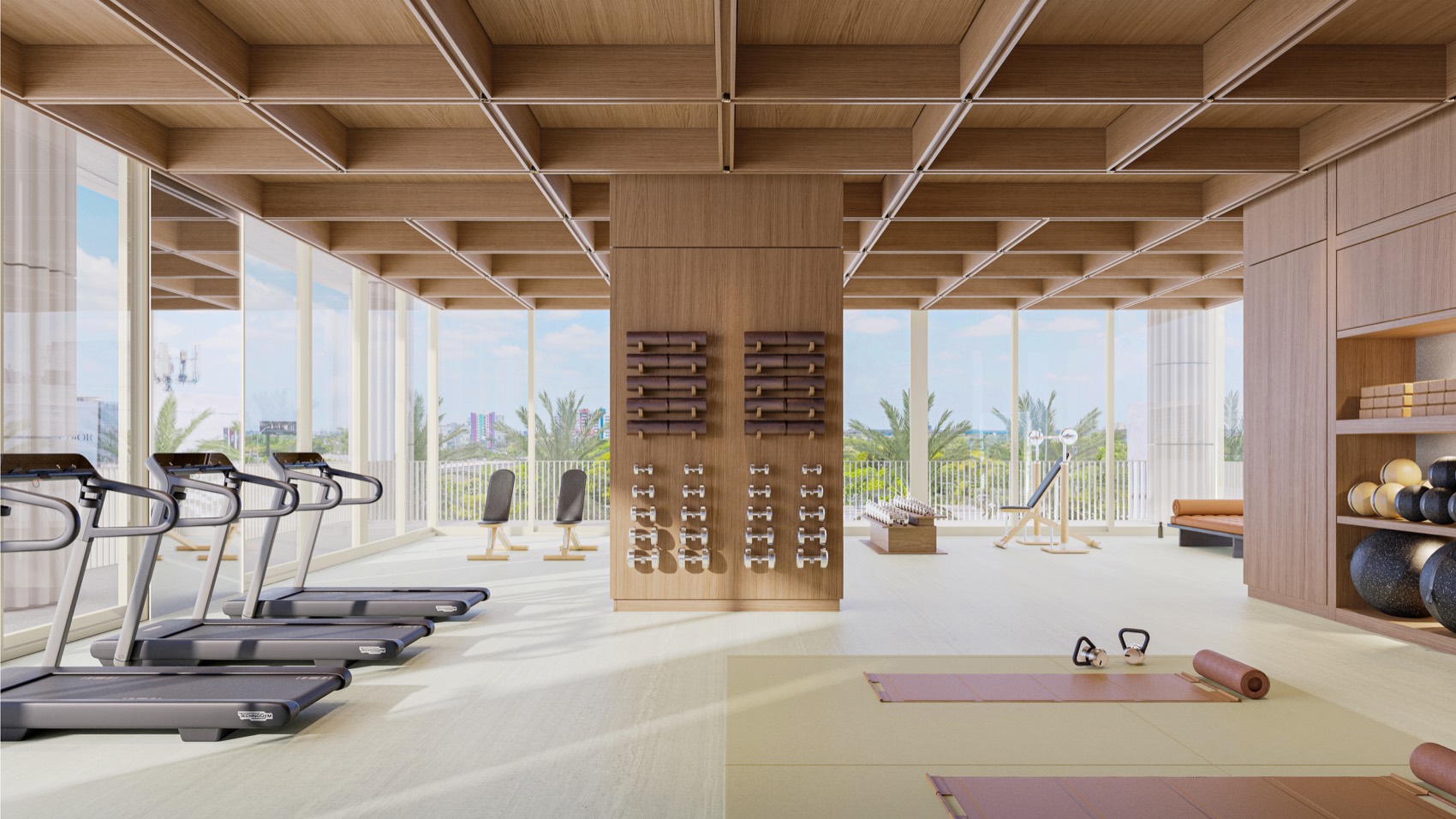 The fitness center at Fouquet's Hotel & Residences — full-height windows, premium equipment, and a private training studio overlooking the Design District.