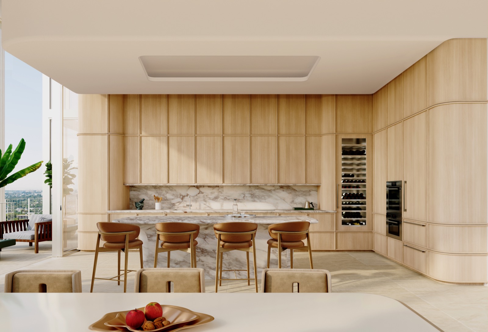 A penthouse kitchen at Fouquet's Hotel & Residences — custom RDAI oak cabinetry, stone countertops and backsplash, and a full Sub-Zero suite, framed by floor-to-ceiling glass.