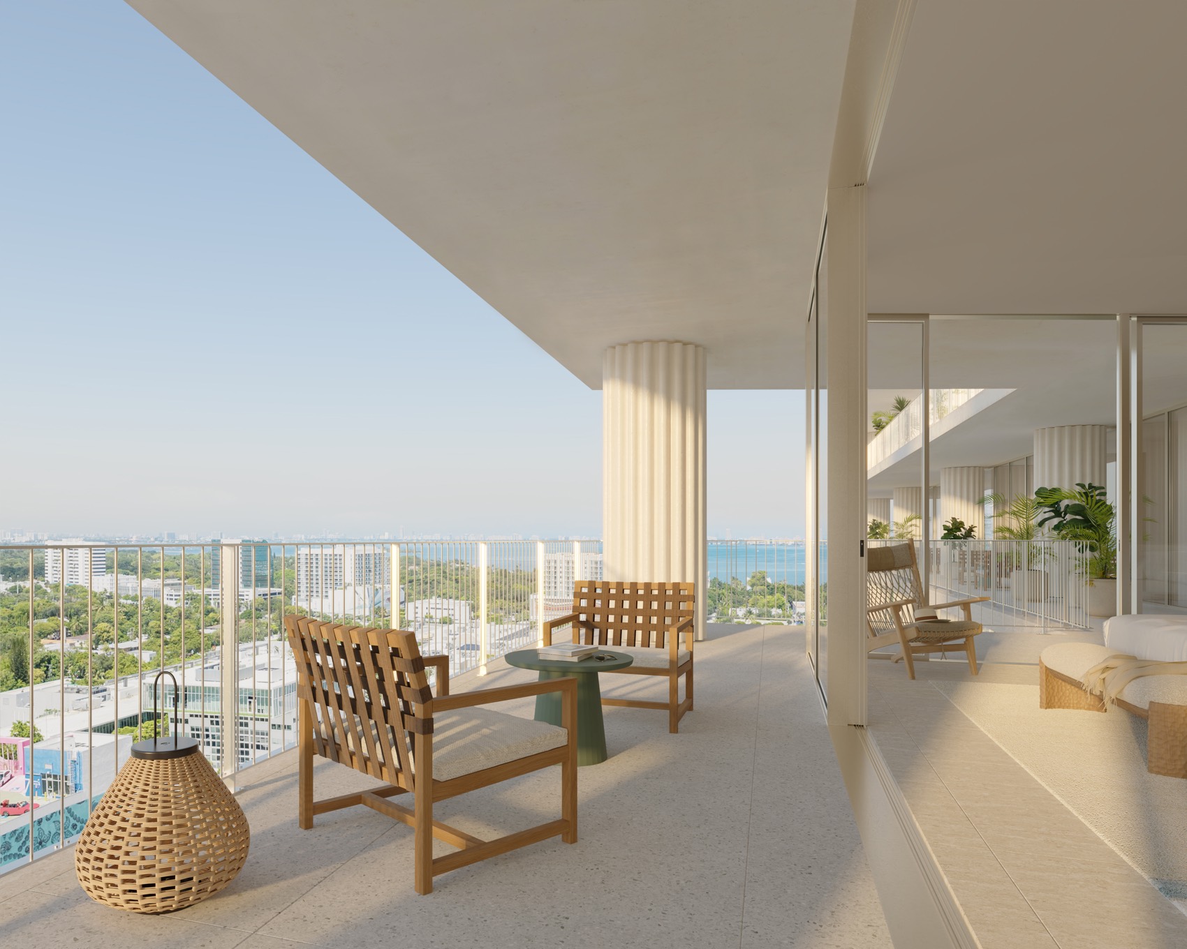 A private terrace at Fouquet's Hotel & Residences — porcelain tile, a custom aluminum and glass railing, and lush planted views across the Design District.