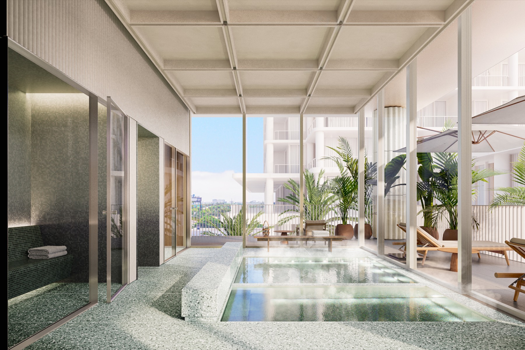 The spa at Fouquet's Hotel & Residences — an indoor-outdoor wellness suite with hydrotherapy water, terrazzo, and floor-to-ceiling glass to a planted terrace, with hammam, sauna, and cold plunge.